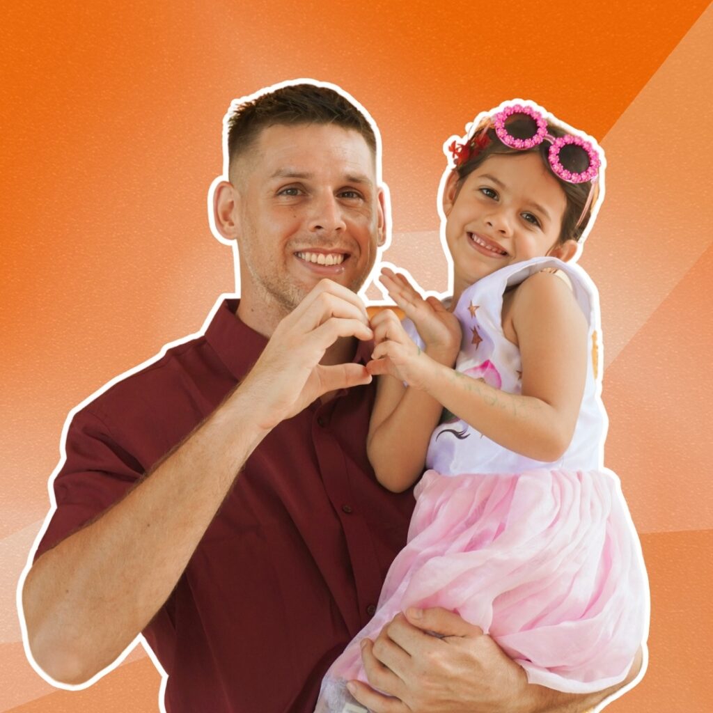 Man holding and hugging a young girl wearing a tiara