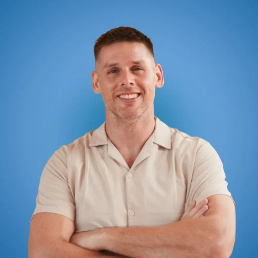 Daryl Urbanski smiling in a beige shirt